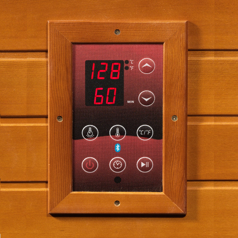 Digital control panel with temperature display on a wooden background