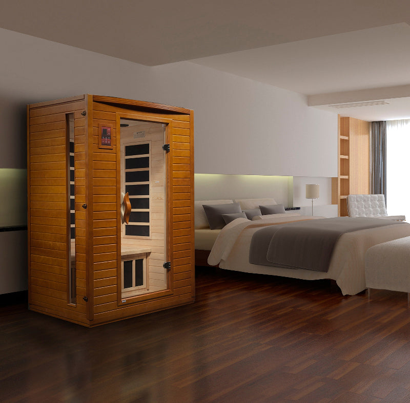 Infrared sauna in a modern bedroom setting with a bed and lamp.