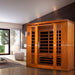 Wooden sauna in a modern room with large windows