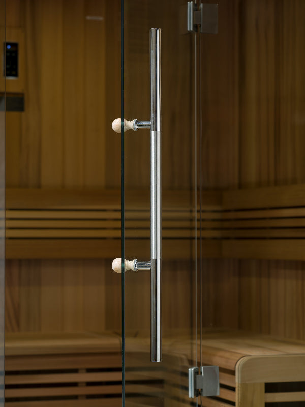 Glass door with metallic handle in a wooden room