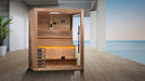 Wooden sauna with interior lights in a modern room with a view of water.