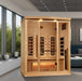 Wooden sauna in a modern room with large windows and a couch.