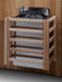 Wooden sauna shelf with black metal tray against a wooden wall.