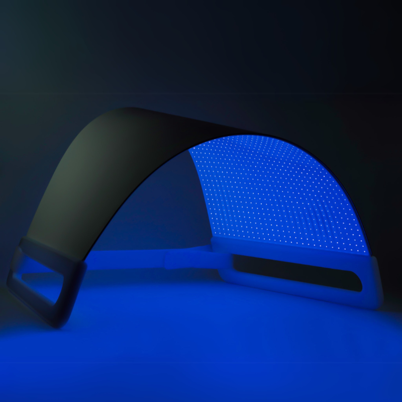 Blue LED light therapy device on a black background