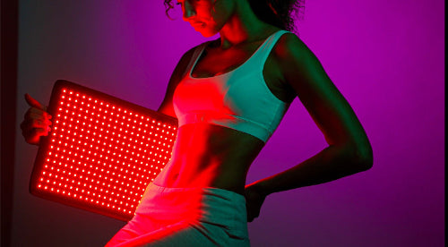 Person holding a red LED panel with a purple background