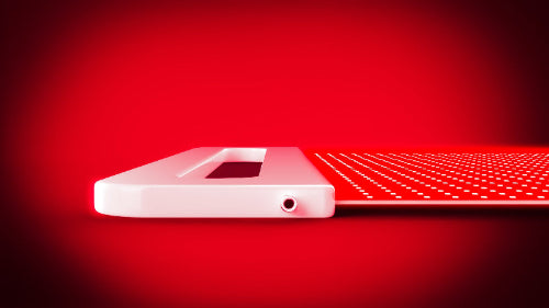white red light therapy panel on black background