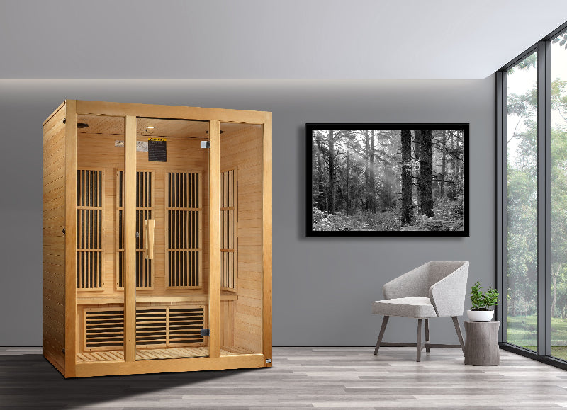 Wooden sauna in a modern room with a forest picture on the wall