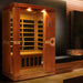 Wooden sauna with glass door in a dimly lit room