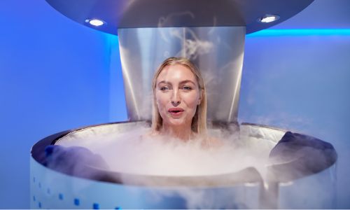 Person inside a cryosauna with blue lighting